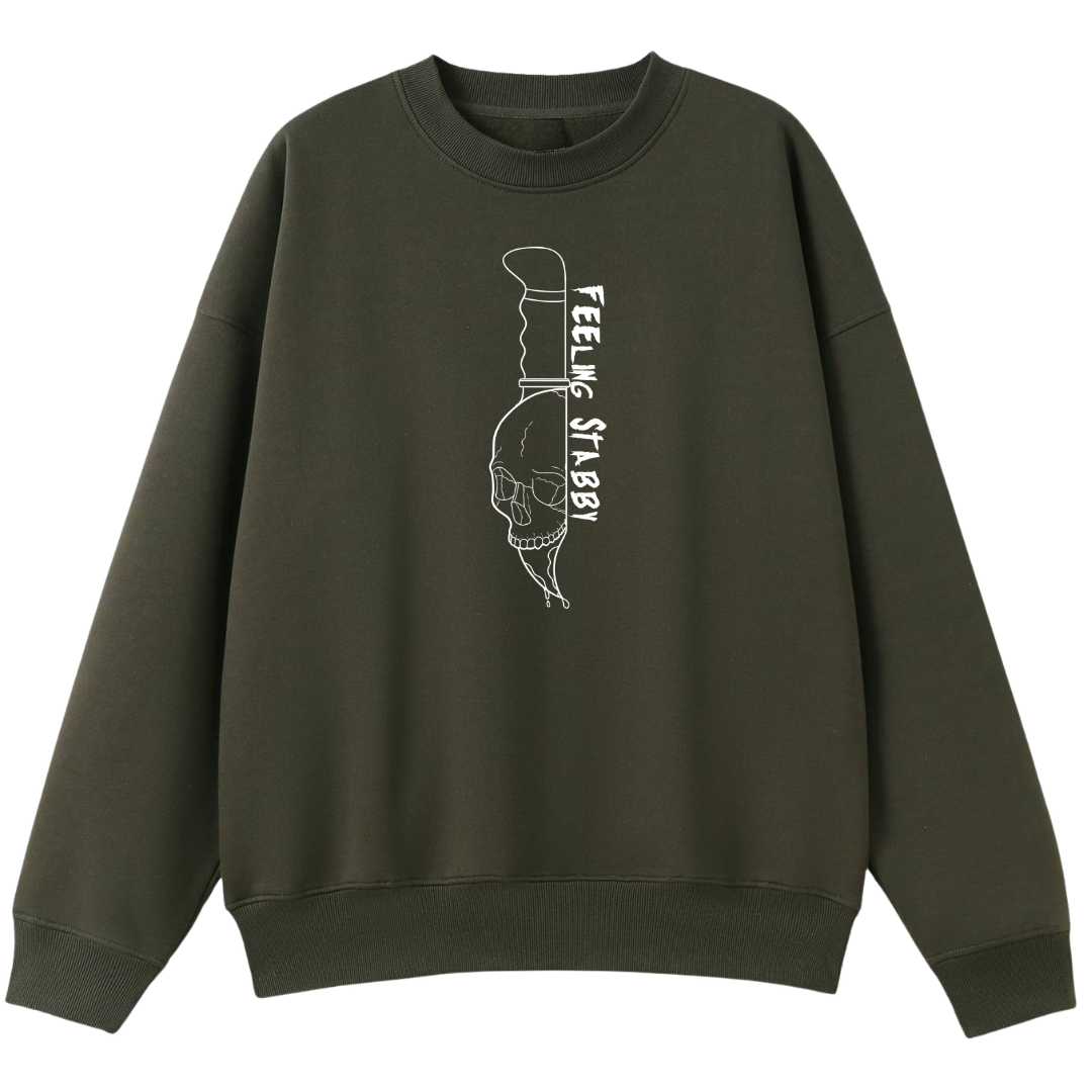 An army green oversized crew neck with the Feeling Stabby graphic printed large on the front, a line drawn skull on a knife blade.