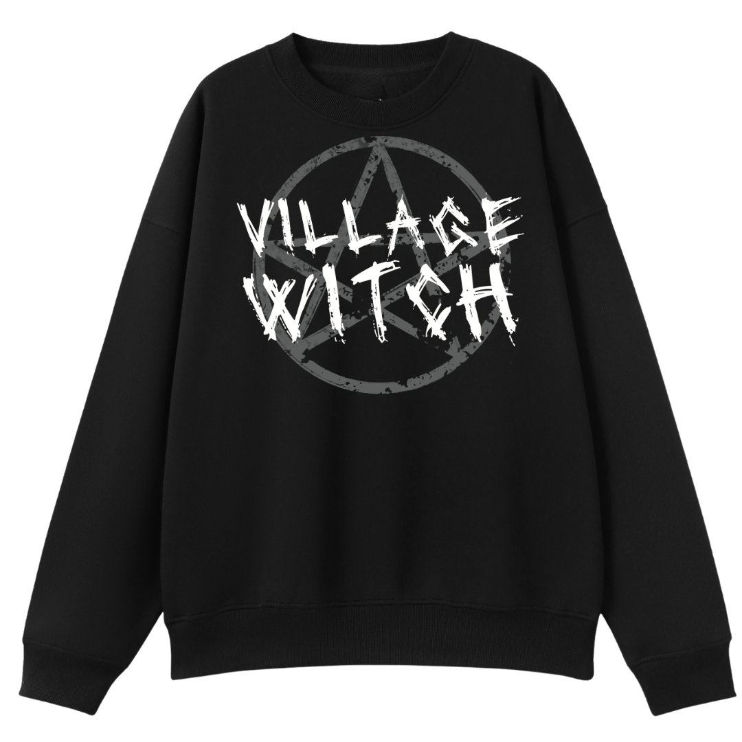 A black oversized crew neck with the Village Witch graphic printed large on the front, scratchy lettering over a weathered pentagram.