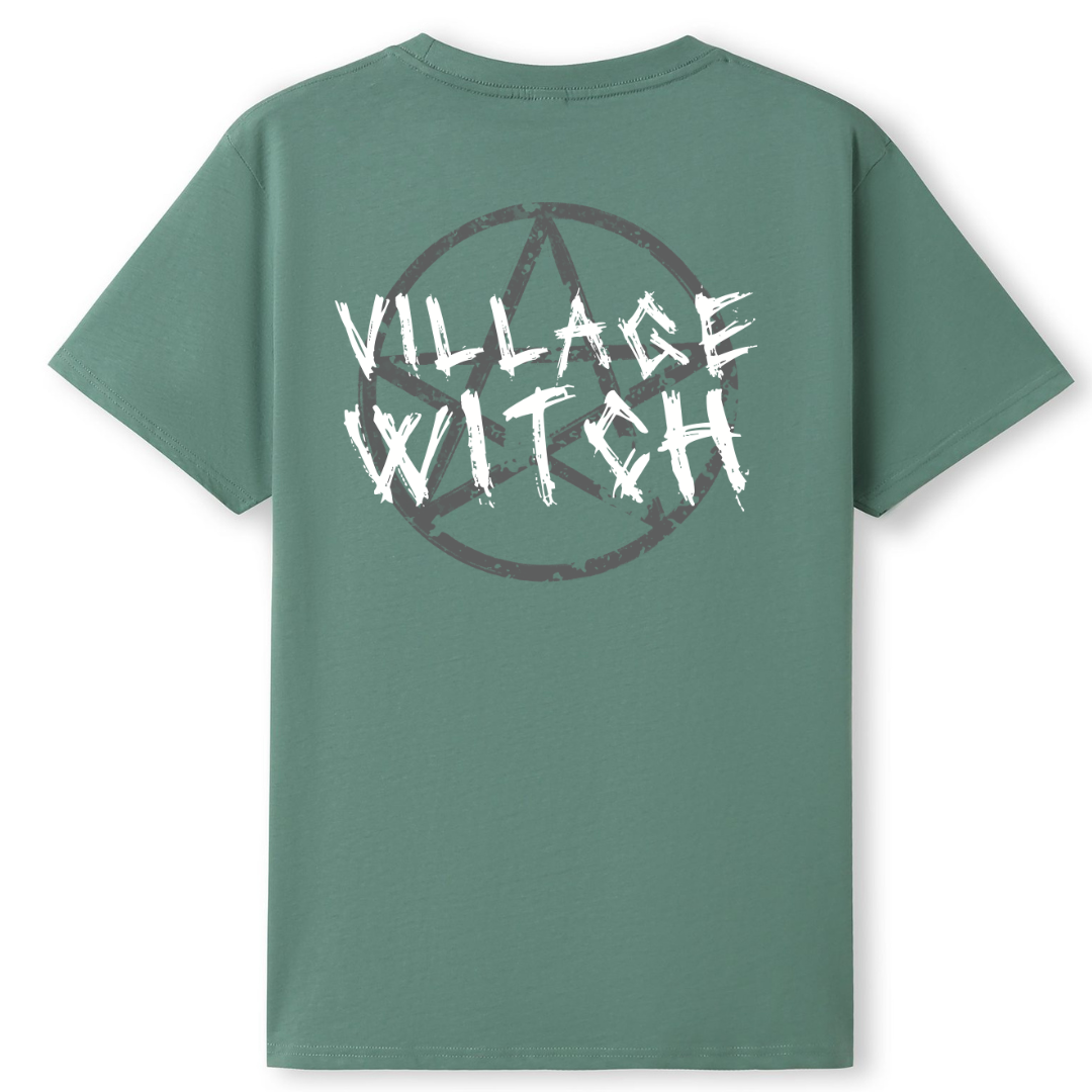 A slate green oversized tee shown from the back, with the Village Witch graphic printed large across the back, scratchy lettering over a weathered pentagram.