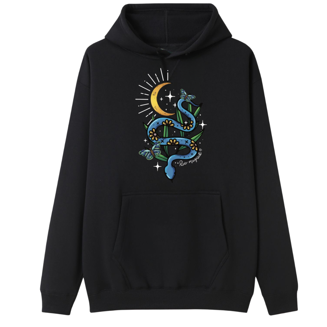 A black oversized hoodie with the Be Magic snake graphic printed large on the front, a blue floral snake with butterflies under a crescent moon.