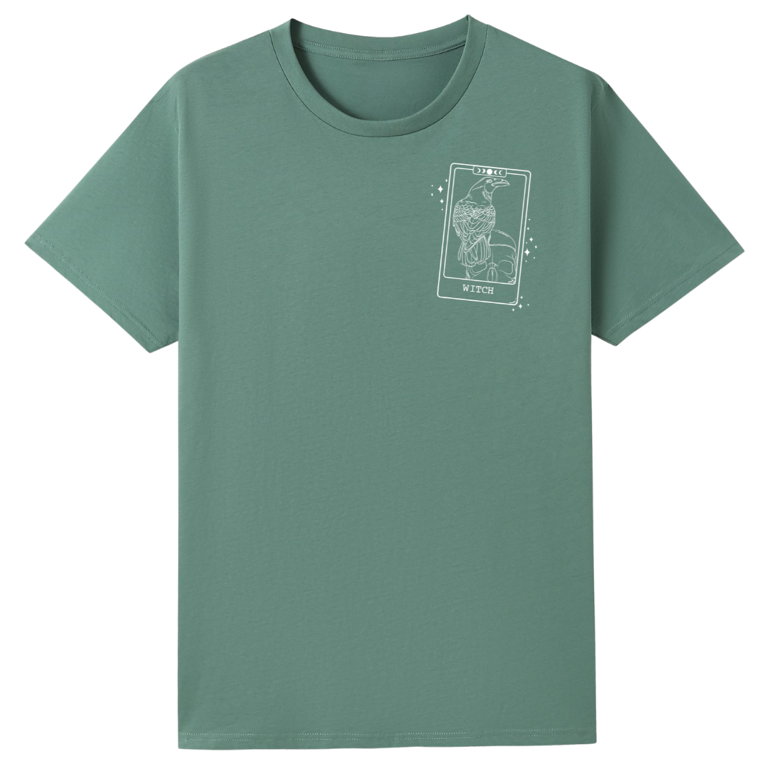 A slate green oversized tee with a small We'll Come Back Again graphic on the left chest.
