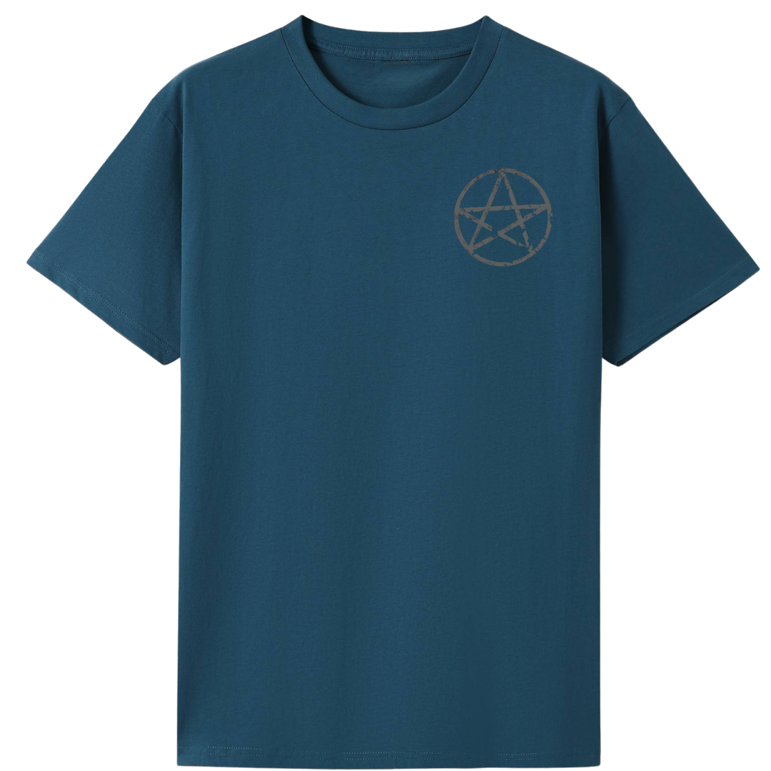 A teal oversized tee with a small Village Witch graphic on the left chest.