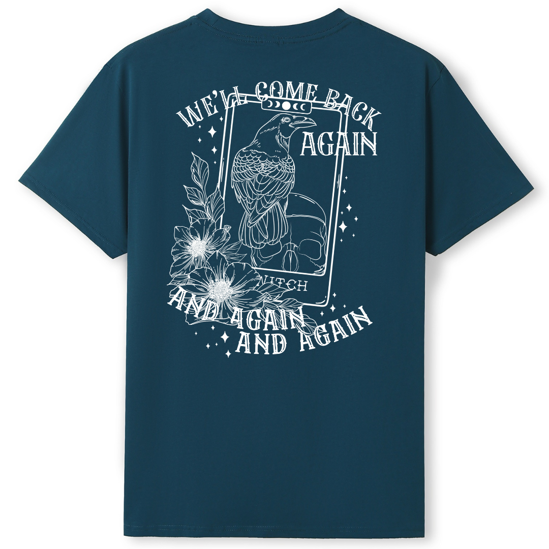 A teal oversized tee shown from the back, with the We'll Come Back Again graphic printed large across the back, a crow on a tarot card framed by flowers.