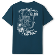 A teal oversized tee shown from the back, with the We'll Come Back Again graphic printed large across the back, a crow on a tarot card framed by flowers.