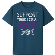 A teal oversized tee with the Support Your Local Coven graphic printed large on the front, purple lettering above a triple moon.