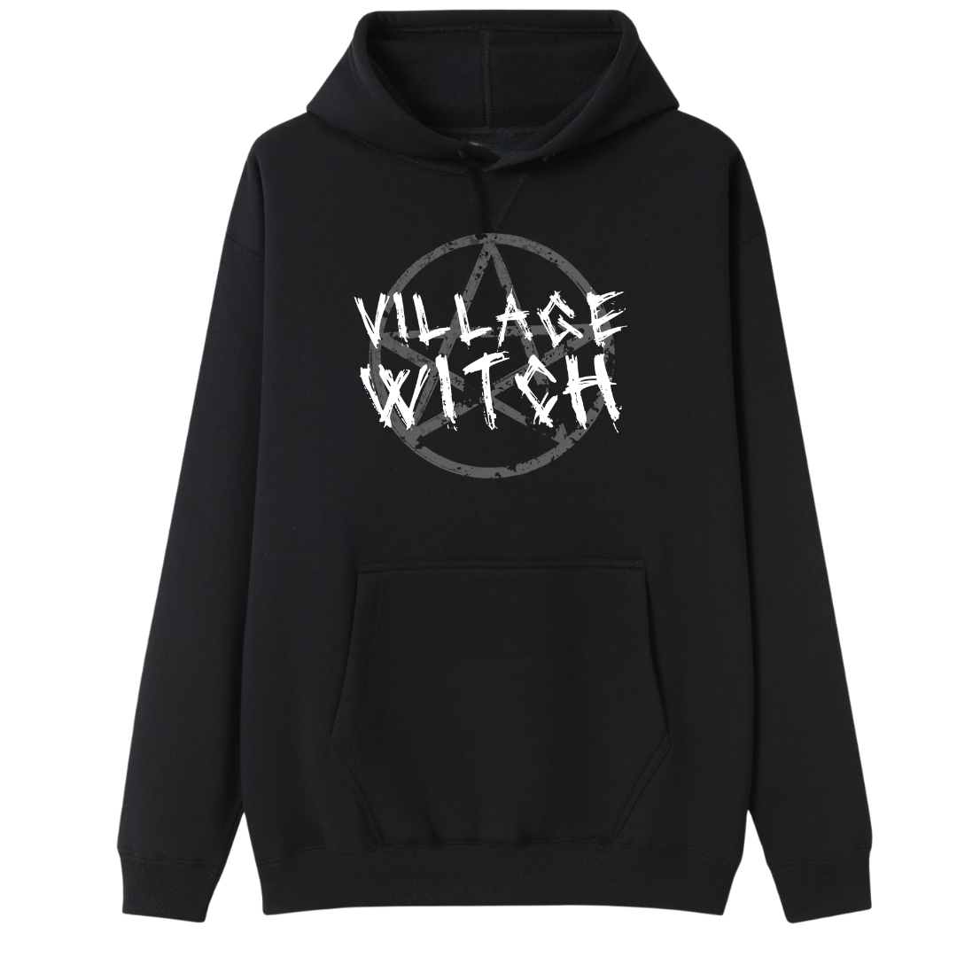 A black oversized hoodie with the Village Witch graphic printed large on the front, scratchy lettering over a weathered pentagram.