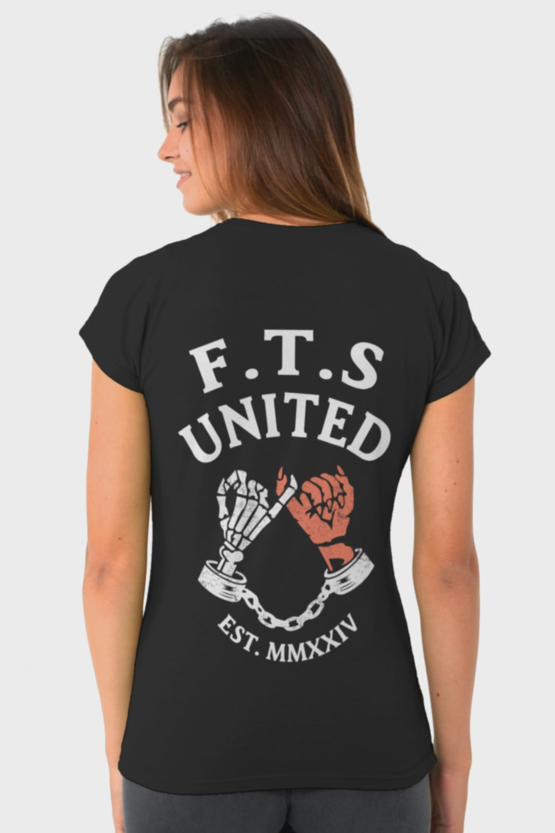 Black Tshirt with a skeleton hand and a devils hand doing a pinky promise. On the top is F.T.S United which stands for "Fuck this Shit United" established in Melbourne in 2024.