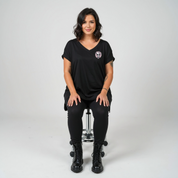 Woman wearing Roses and Bones skull graphic oversized black V neck tee plus size Australian streetwear brand Bae Bands