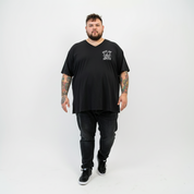 Woman wearing Surviving oversized black V neck graphic tee plus size Australian streetwear brand Bae Bands
