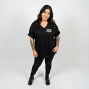 Woman wearing Zero Fucks oversized black V neck graphic tee plus size Australian streetwear brand Bae Bands